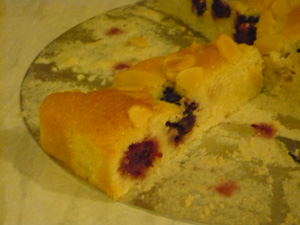 Slice of almond and blackberry tart